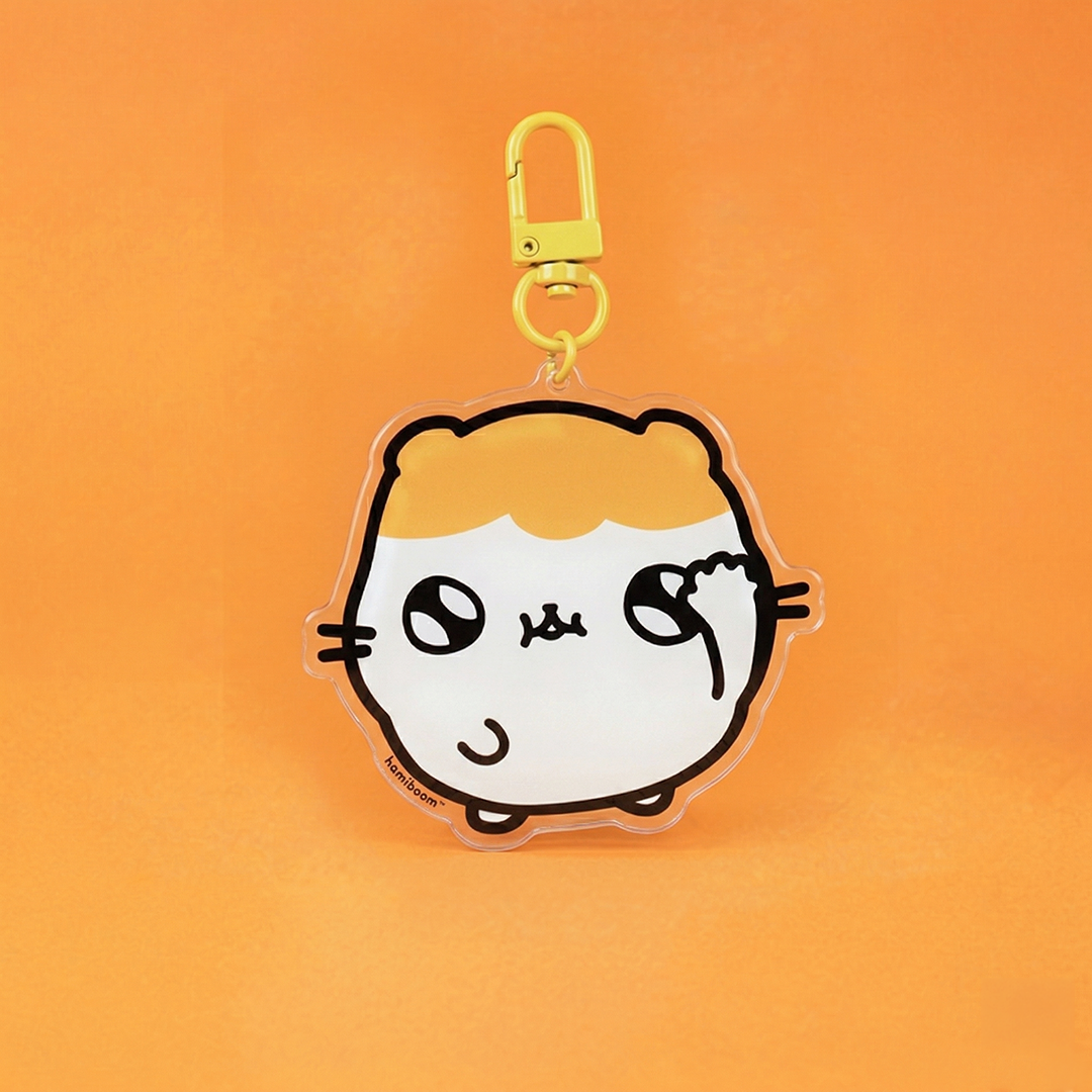 Hamiboom Keychain in front of an orange background