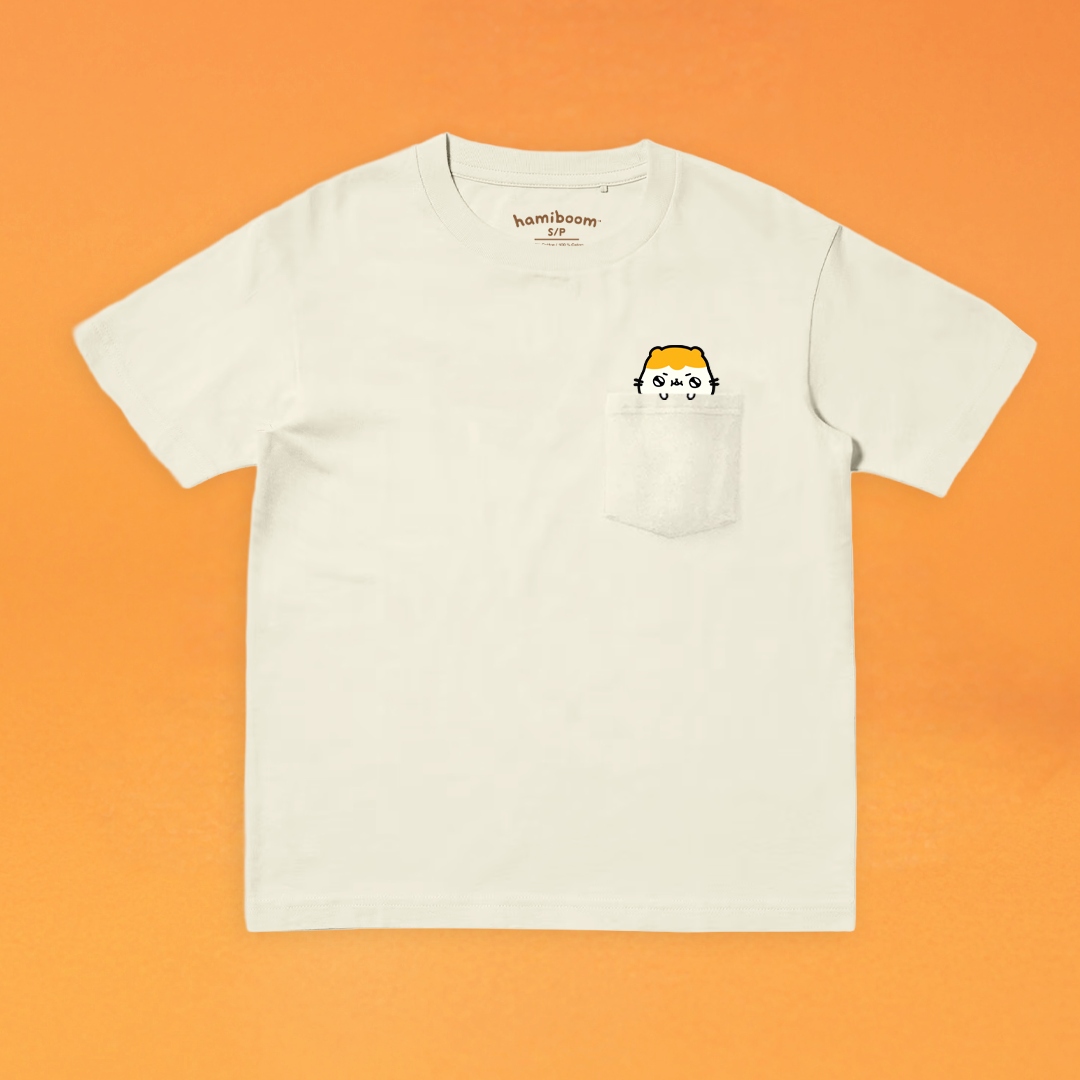 Sand colored t-shirt with a small hamiboom graphic on an orange background