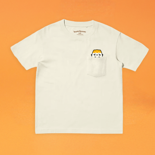 Sand colored t-shirt with a small hamiboom graphic on an orange background